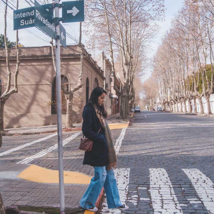 Woman walking through the streets of the old town of Colonia del Sacramento.