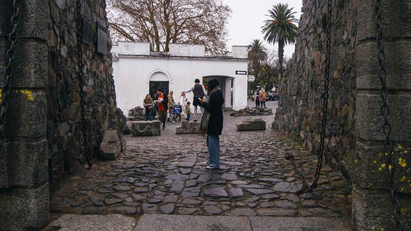 Woman crossing the Portón de Campo in Colonia del Sacramento.