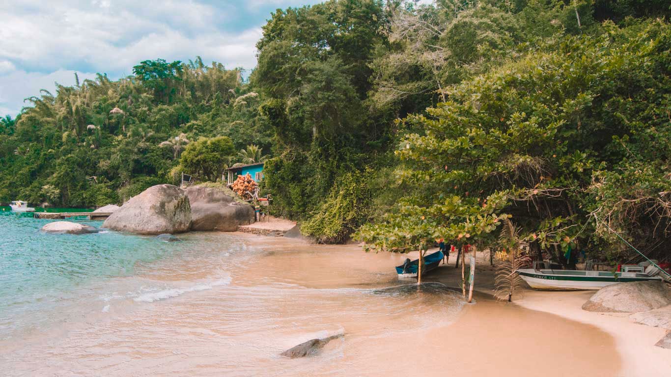 Paraty Beach in Rio de Janeiro, where the blue sea blends seamlessly with the green of nature.