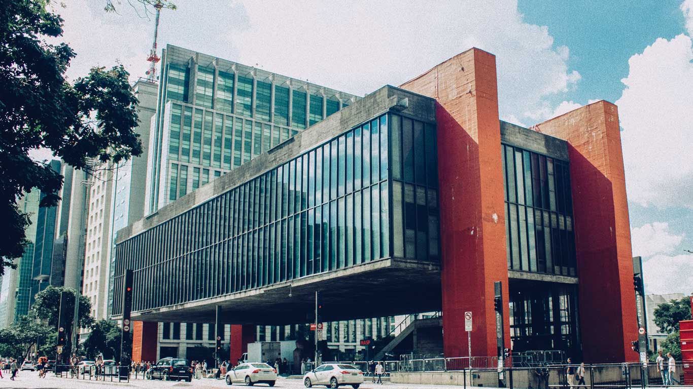 The iconic São Paulo Museum of Art (MASP), featuring its distinctive modernist design with a suspended structure supported by bold red pillars, located on Avenida Paulista. A visit to MASP is one of the most popular things to do in São Paulo, blending art and architecture.