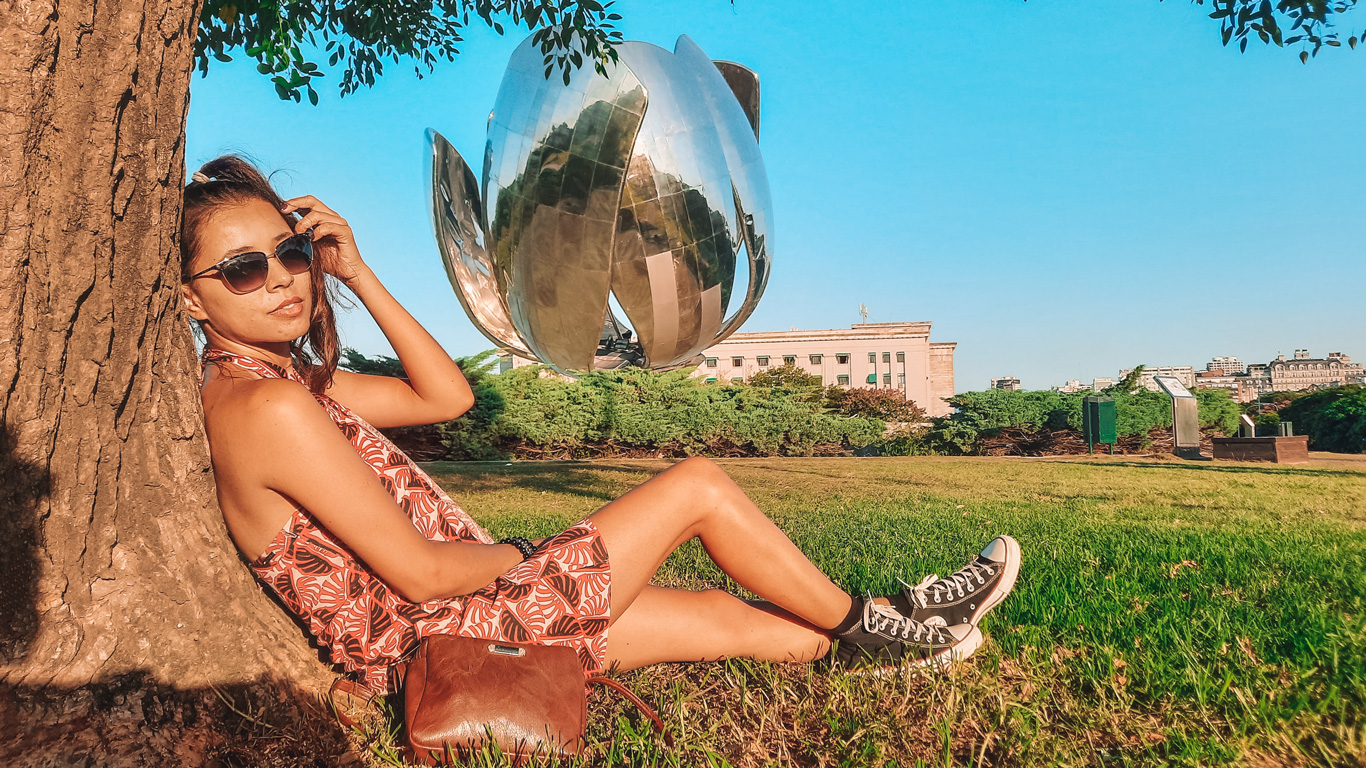 floralis-generica-recoleta Woman lounging under a tree in front of the giant metallic flower sculpture, Floralis Genérica, a popular photo op and unique.