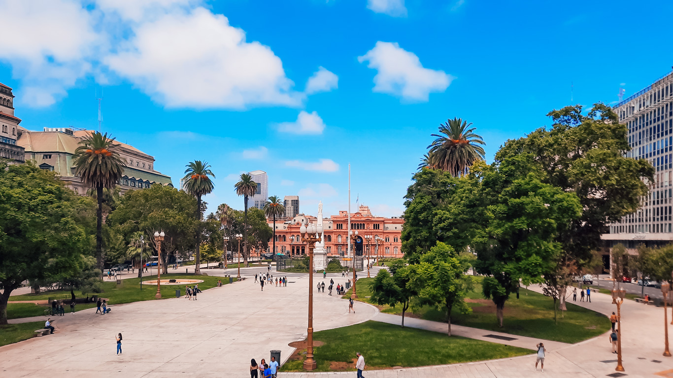 plaza-de-mayo-2 Wide view of Plaza de Mayo with palm trees and walkways leading to the Casa Rosada, a historic and political hub and one of the most essential things to do in Buenos Aires.